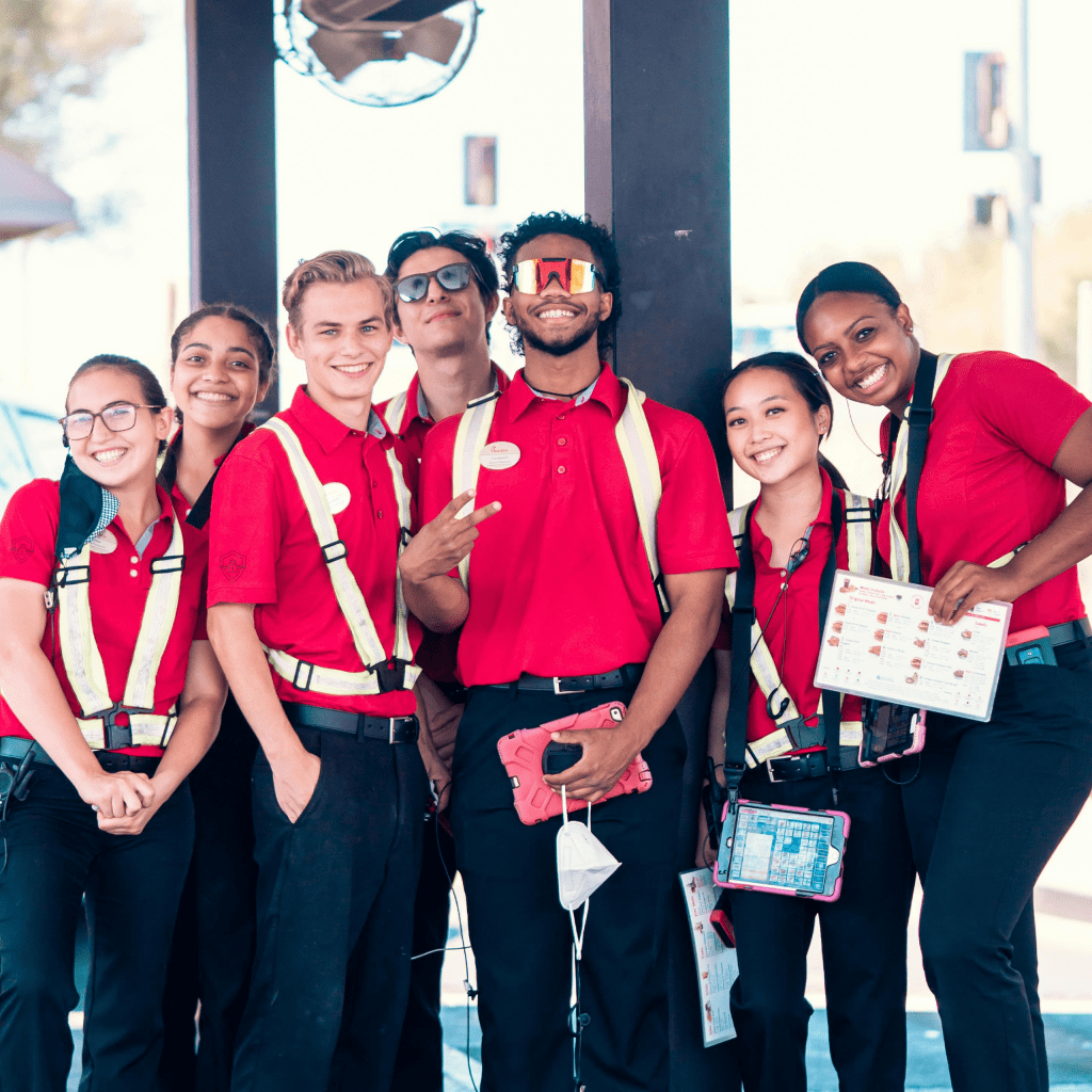 Team of Employees in Red Uniforms