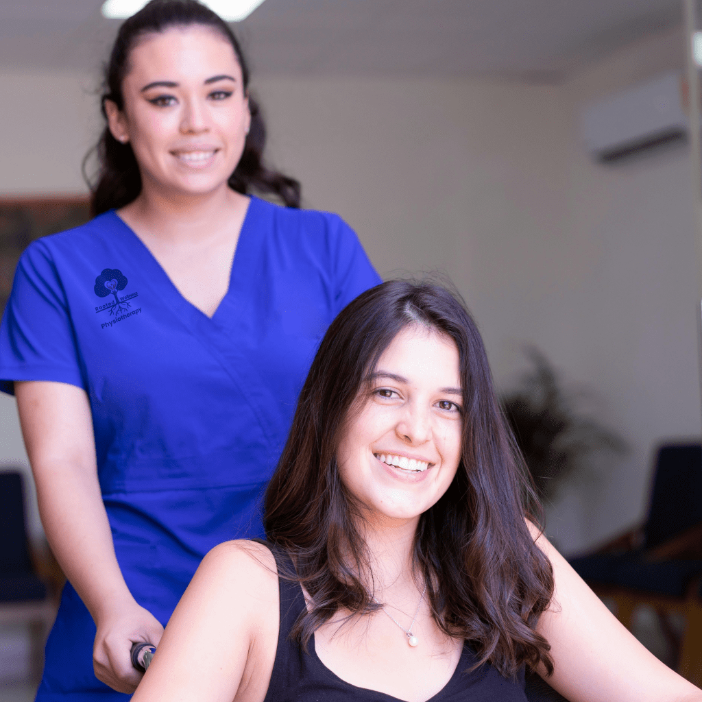 Nurse with smiling woman in wheelchair